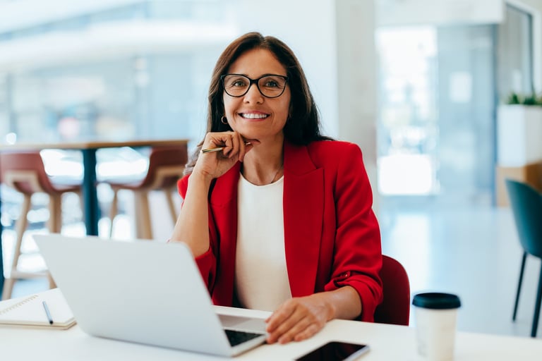 Business professional working on her laptop at an office desk, exuding confidence and focus